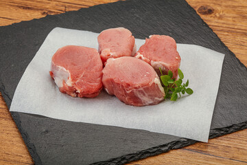 Raw pork medallion served rosemary