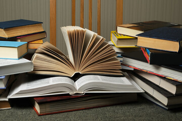 a stack of open books lies on the table