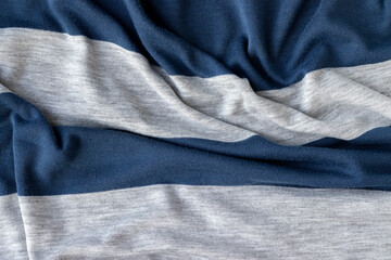 Cotton jersey striped fabric with pills texture. Crumpled blue and gray textile background