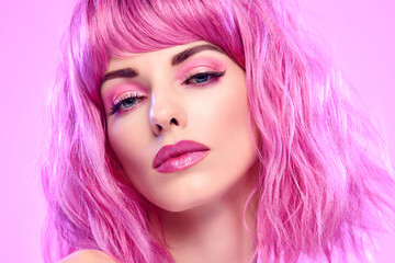 Beauty Fashion woman with Colorful Pink Dyed Hair. Girl with blue eyes, perfect Makeup and Hairstyle. Beautiful smiling model portrait, fashionable pink make up, hair. Skincare concept