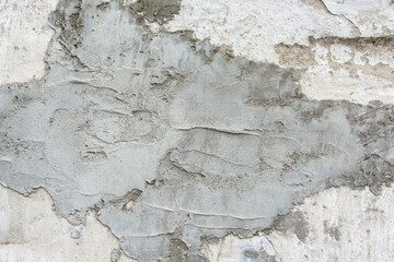 new uneven layer of cement plaster on the old wall as a natural background