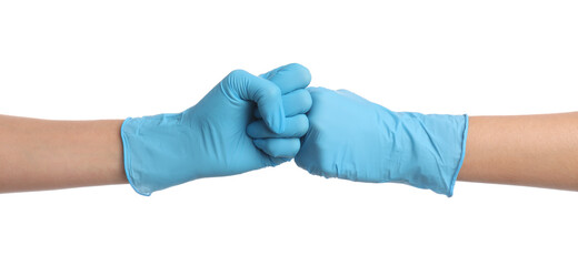 Doctors in medical gloves making fist bump on white background, closeup