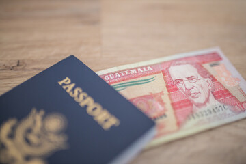 Fototapeta premium Ten Quetzales Bill Partially Inside a United States of America Passport