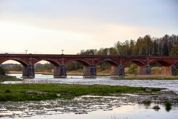 Old brick bridge over river Venta.