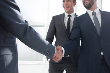 handshake of business partners in a modern office
