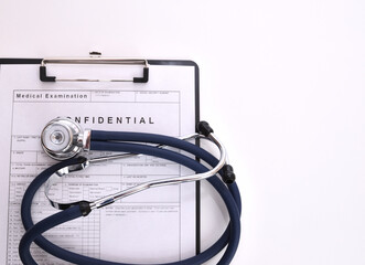 Patient examination form with rolled-up stethoscope above