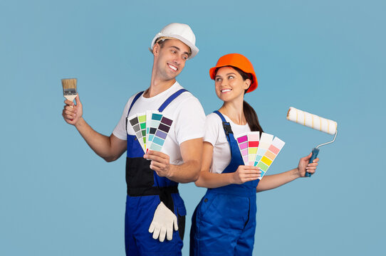 Cheerful Couple In Hard Hats Posing With Paint Brushes And Color Swatches - Powered by Adobe
