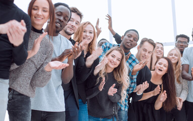 group of diverse young people are applauding while looking at you