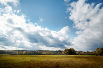 Autumn landscape, field, the sky is covered with clouds, rays of light