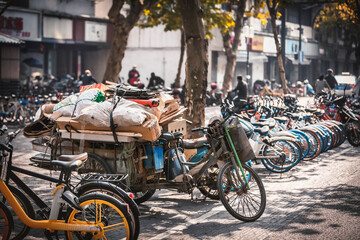 Fototapeta na wymiar Bicycle with waste on the sidewalk, Hangzhou, China