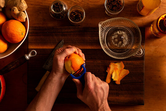 Peeling an orange for a mulled apple cider and  orange cocktail.