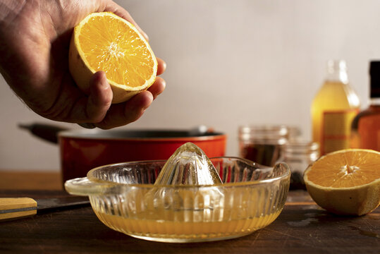 Juicing an orange for a mulled apple cider and orange cocktail.