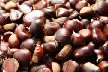 Fresh edible sweet chestnuts as background, closeup
