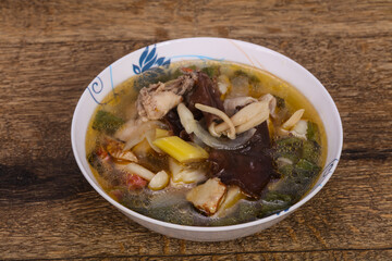 Thai style soup with meat and mushrooms