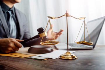 Business and lawyers discussing contract papers with brass scale on desk in office. Law, legal...