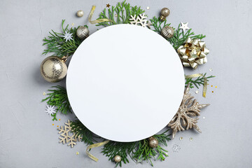 Flat lay composition with Christmas decor and blank card on light grey background. Space for text