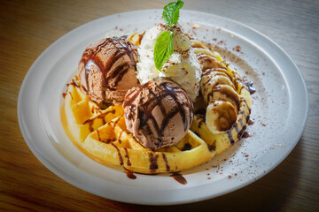 Chocolate topping ice cream on delicious vanila waffle