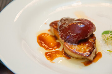 fried  foie gras on white plate