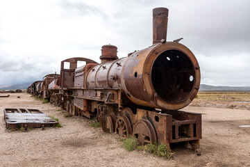 Fototapeta na wymiar Old rusty locomotive abandoned in a train cemetery. Uyuni, Bolivia