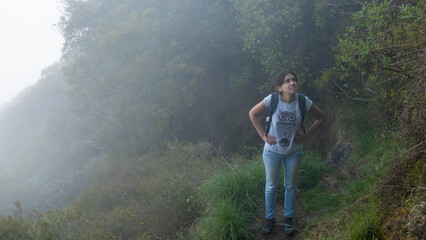 Tired woman hiking in the jungle and mountains