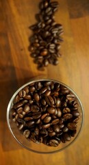 glass with coffee beans on a wooden table