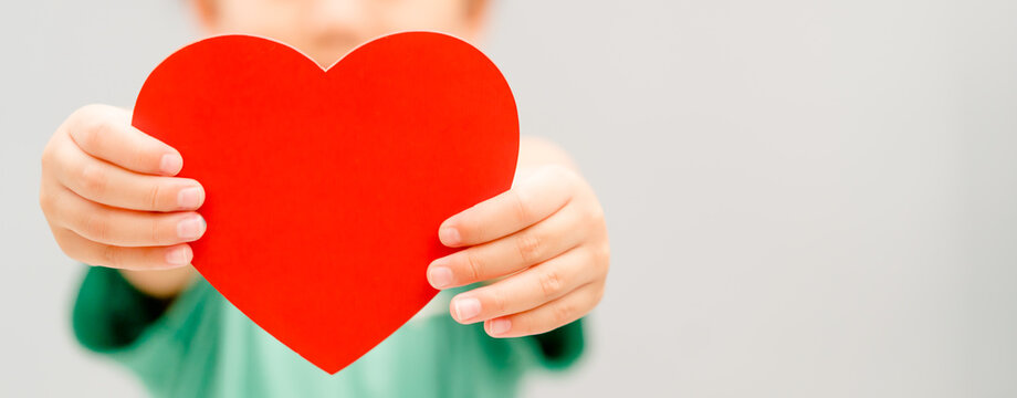 Child hands holding red heart for share Donate.Health care pediatric.family insurance.World heart day, world health day,CSR responsibility, Adoption foster kids.Worship with faith.Banner background.