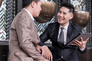 businessman talk business deal at skyscraper office lounge with cityscape business zone background