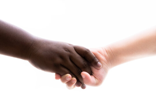 hands touching hands holding between african and caucasian kids over white background.No racism End racism.protesters people.black lives matter for revolution protest.People and Unity.reconcile peace.
