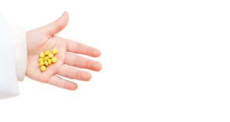 medicines on baby hand, yellow pills, small drug.