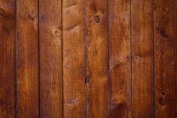 Obraz premium Old wooden background, close-up. Brown vertical boards. Facing the exterior walls of the house.