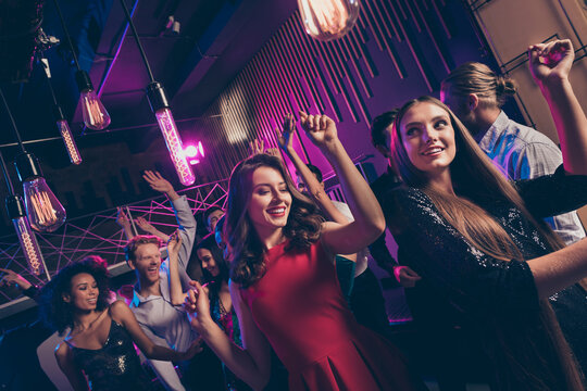 Nice attractive cheerful buddies fellows dancing having fun enjoying corporate event relax chill free time in dark night music club indoors