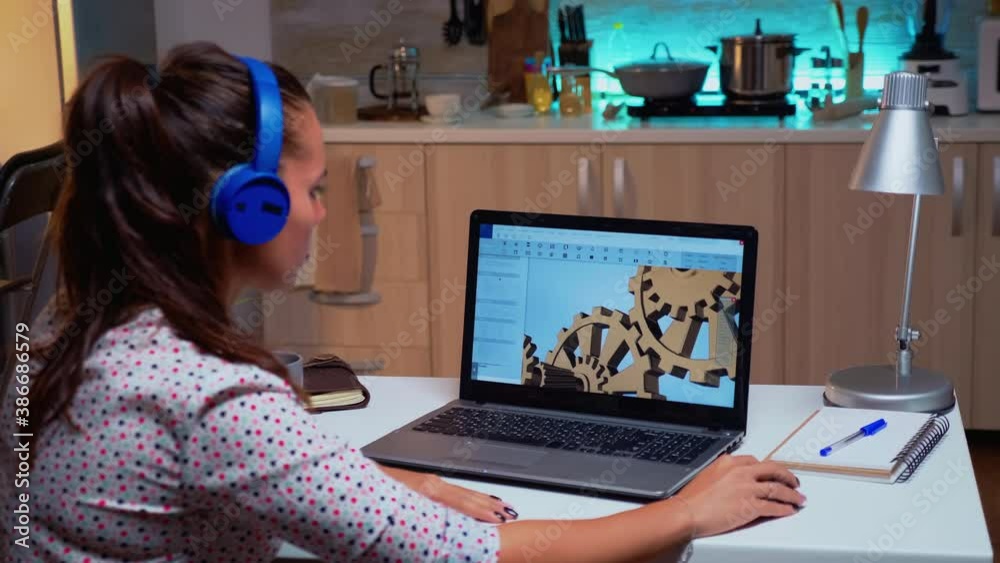 Poster design engineer working on a 3d component in cad program on laptop from home. industrial female empl