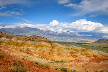 Natural attraction of Altai mountains, Martian landscapes. Stunning panorama with a ridge of rocks against a blue sky with white clouds. Popular tourist routes in Russia.