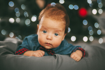 Portrait of a beautiful little boy on the background of Christmas lights. Holiday, event. Christmas and New year concept