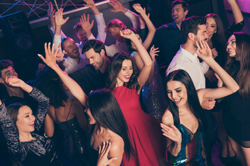 Attractive elegant trendy cheerful crowd dancing enjoying celebratory bachelor evening chill relax in dark night club indoors © deagreez