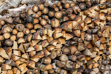 Firewood stacked in nice rows prepared for the winter, shallow selective focus. Travel photograph, rural landscape, Strandzha mountain, Bulgaria