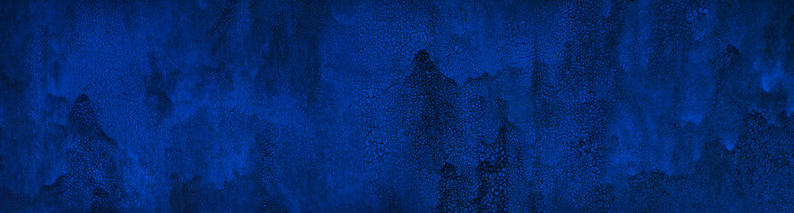 Old blue metal painted wall. Cracked paint texture. Dark blue background with paint drips .Web baner. Website header.