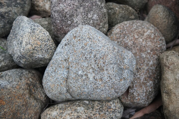 plutonic granite rock on nature background. Granite, coarse- or medium-grained intrusive igneous rock that is rich in quartz and feldspar