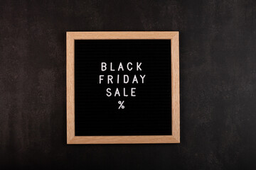 Creative promotion composition for Black friday on black background. Flat lay, top view, overhead, mockup, template. Minimal abstract background. Online shopping, sale, promo. Web banner