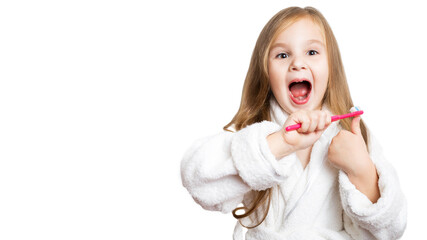 little happy beautiful preschooler girl brushes her teeth with a pink toothbrush with her mouth wide open looking at the camera on a white background with copy space.