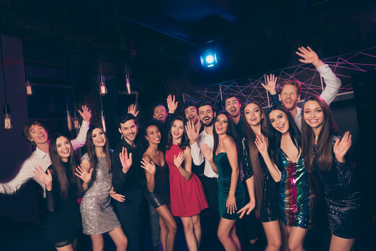 Portrait of lovely cheerful company meeting having fun waving hi hello celebratory day visit event in dark night club indoors - Powered by Adobe