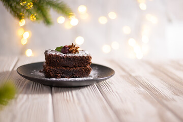Chocolate cake on the festive celebration table with christmas decorations