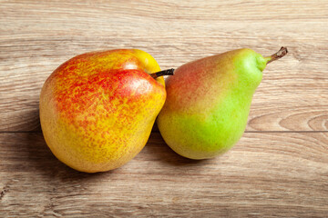 Two pears top view. Fresh ripe organic pears on a wooden background. Vegetarian, vegan healthy food. Diet organic product. Selective soft focus.