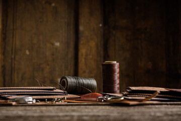 Leather craft tools on old wood table. Leather craft workshop.