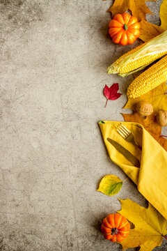 Thanksgiving Flat Lay With Table Setting Leaves And Pumpkins, Overhead View