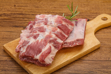 Raw pork ribs served rosemary
