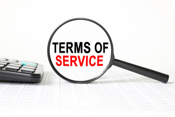 text TERMS OF SERVICE in a magnifying glass, office concept, business concept, Finance