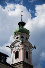 Fototapeta na wymiar Church tower of the Spitalkirche in Innsbruck with blue sky and clouds