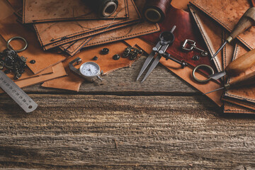Leather craft tools on old wood table. Leather craft workshop.