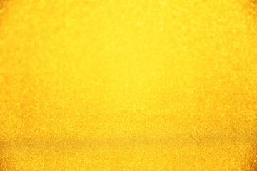 Obraz premium Luxury gold glitter texture with bokeh as background, de-focused. concept for studio backdrop , chrismas , holiday , happy new year , decoration.
